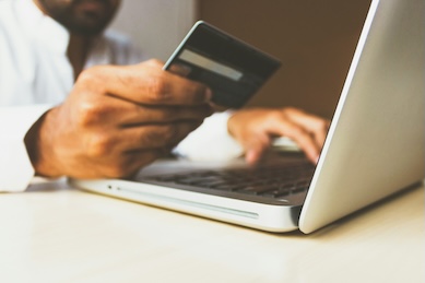 person using card to pay off debt